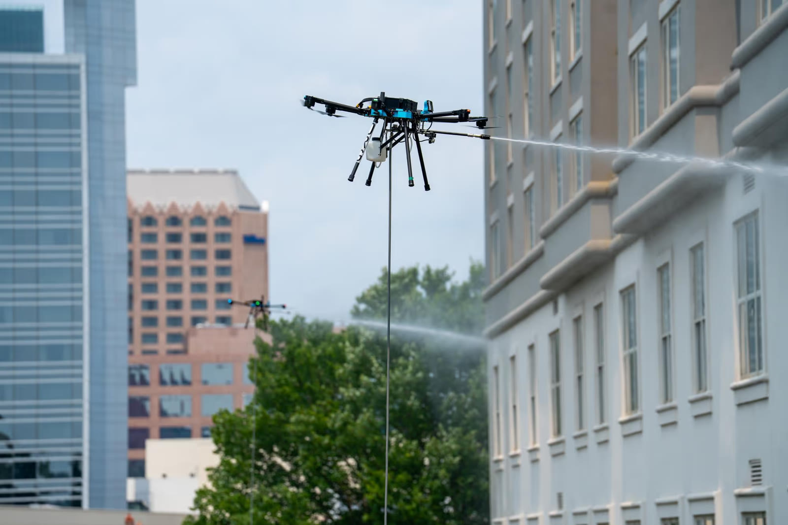 Dron de limpieza de Aeral trabajando en la parte alta de un edificio